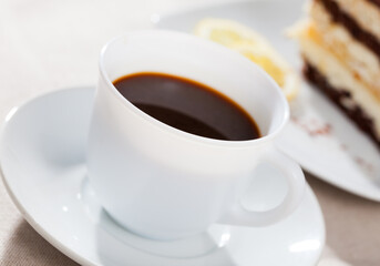 Closeup cup of black coffee with chocolate dessert