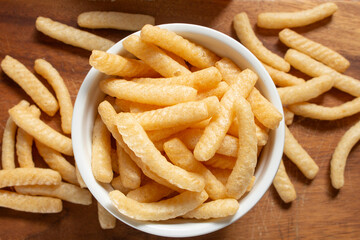 A top down view of a bowl of baked shrimp chips.