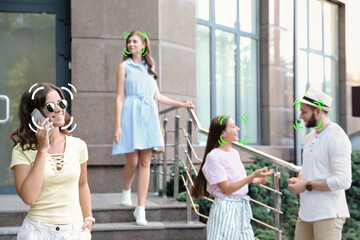 Facial recognition system identifying people on city street, selective focus