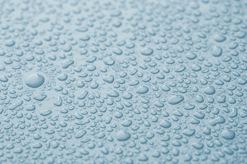 Many water drops on light blue background