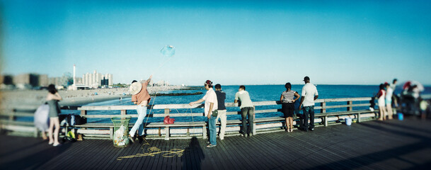 Panoramic view of tourists on the pier at Coney Island, Brooklyn, New York City, New York State, USA.