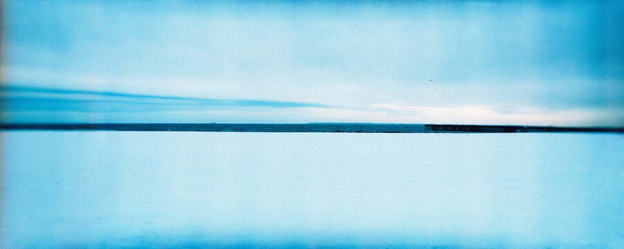 Panoramic image of Coney Island beach covered in snow in the winter
