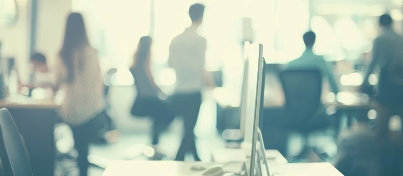 Blurred scene of workers walking in a bright contemporary office environment