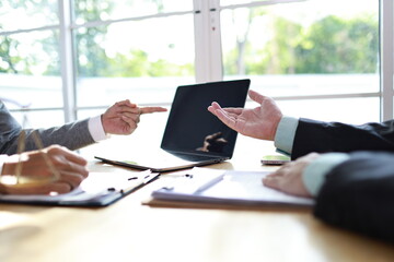 A male executive and female colleague discuss documents in a corporate office, demonstrating leadership, collaboration, and professional teamwork in a business agreement setting.