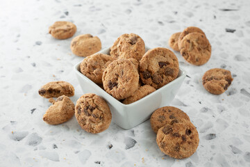 A view of a bowl full of mini chocolate chip cookies.