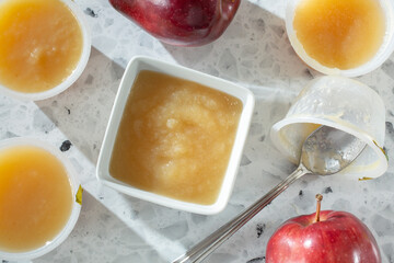 A top down view of a small bowl of apple sauce.