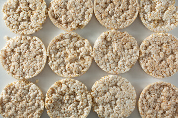 A top down view of a layer of rice cakes, as a background.