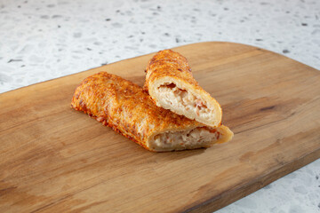 A view of a halved savory pastry turnover, from a popular warehouse grocery store.