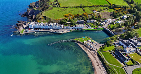 Aerial Drone View of Cushendun village Glendun on the Irish Sea Co Antrim Northern Ireland on a sunny day with a blue sky