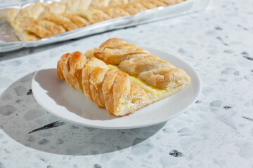 A view of a slice of braided Danish custard pastry.