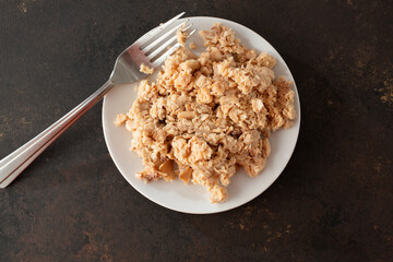 A top down view of a plate of canned pink salmon meat.