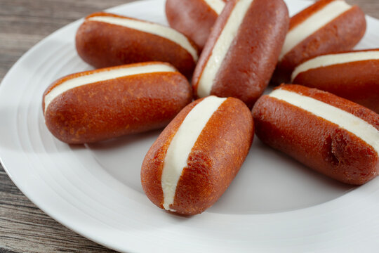 A closeup view of a plate of chum chum malai jamun.