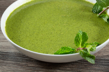 A view of a big bowl of green chutney.