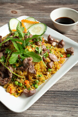 A view of a plate of beef fried rice.