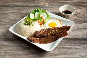 A view of a plate of broken rice, featuring BBQ short rib.