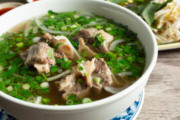 A closeup view of a bowl of oxtail pho.