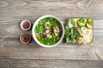 A top down view of a bowl of oxtail pho.