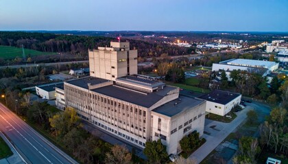Fototapeta premium Aerial View of Abandoned Industrial Building at Sunset in Landscape