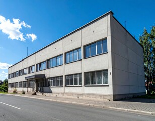 Modern Industrial Building Exterior with Large Windows and Clear Sky