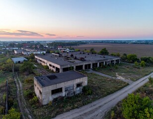 Abandoned Industrial Building Surrounded by Overgrown Vegetation