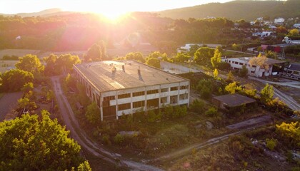 Abandoned Industrial Building Surrounded by Nature at Sunset