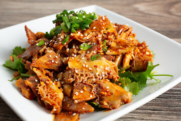 A closeup view of a plate of stewed pork intestines.