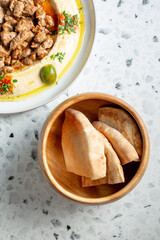A top down view of pita bread and hummus.