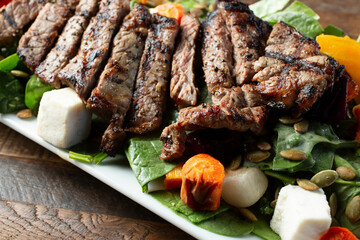 A closeup view of a rustic steak salad.
