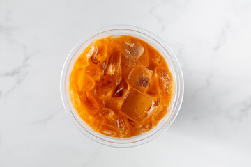 A top down view of a Thai tea drink.