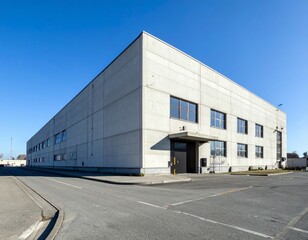 Obraz premium Modern Concrete Industrial Building with Clear Blue Sky Background