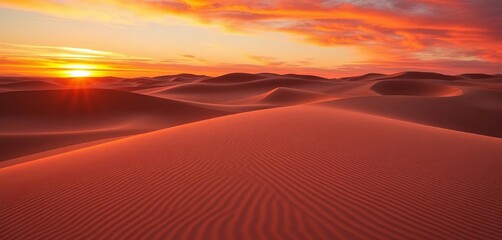 Naklejka premium Fiery sunset paints the sand dunes, leaving long shadows, panorama, ocean