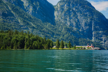 Konigssee Lake in Bavaria Germany with Church by the Lake White Boat Forested Mountain and Beautiful Sunny Trekking in Berchtesgaden German Alps. High quality photo