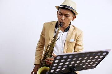 Portrait Of Professional Musician Male In Suit Playing On Saxophone