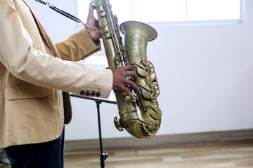Close Up Of Unrecognized Male Jazz Musician Playing The Saxophone While Standing