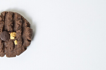 Top view of one cookie with peanut and chocolate chips. Chocolate cookies. Freshly Baked Homemade. perfect for bakery advertisements and dessert menus. Clipping path. Isolated on white background.