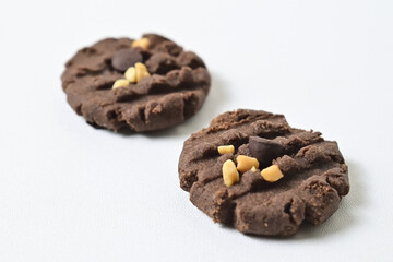 Close up view of two cookies with peanut and chocolate chips. Freshly Baked Homemade. perfect for bakery advertisements and dessert menus. Clipping path. Isolated on white background