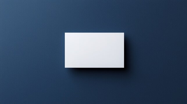 A blank white business card centered on a textured dark blue background.