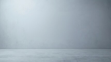 Minimalist empty room with a textured grey wall and smooth concrete floor, creating a clean, modern atmosphere.