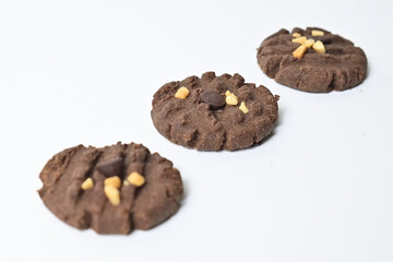 Top view of three cookies with peanut and chocolate chips. Freshly Baked Homemade. perfect for bakery advertisements and dessert menus. Clipping path. Isolated on white background. high angle, above.