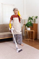 Cheerful Woman Vacuuming, Listening Music with Headphones