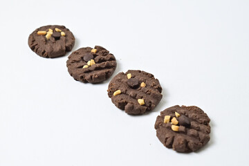 Photo of four cookies with peanut and chocolate chips. Freshly Baked Homemade. perfect for bakery advertisements and dessert menus. Clipping path. Close up. Isolated on white background.