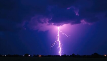 Dramatic bolt of lightning striking a dark stormy sky at night , rain, tempest, force of nature