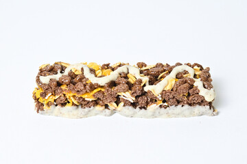 Side view of Healthy Snack, Cereal Bar, Multigrain Bar with coffee extract isolated on white background. Tiramisu delight. Clipping path. Close up.
