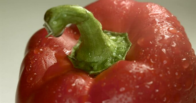 Close-Up of Red Bell Pepper Being Washed under a Stream of Water