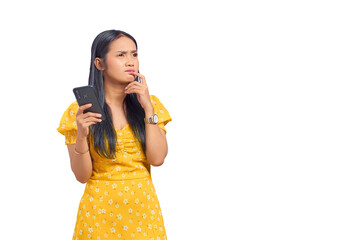 Portrait of pensive young Asian woman using a mobile phone and looking away isolated on transparent background