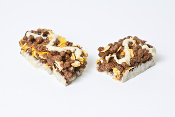 Close up view of Healthy Snack, Cereal Bar, Multigrain Bar with coffee extract isolated on white background. Tiramisu delight. Clipping path. Broken. 