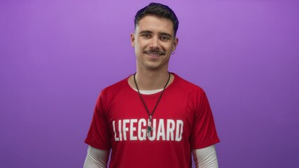 Young hispanic man lifeguard in red t-shirt stands confidently against isolated purple background wall