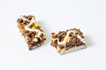 Close up view of Healthy Snack, Cereal Bar, Multigrain Bar with coffee extract isolated on white background. Tiramisu delight. Clipping path. Broken. 