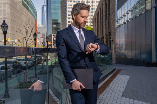 Business deadline. Businessman late for business deadline. Time management. Punctual man check time on watch being late. Waiting for partner. Punctual businessman checking time outdoor