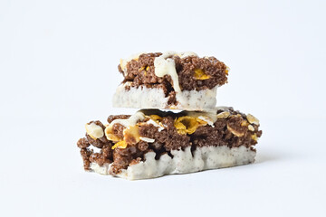 Close up view of Healthy Snack, Cereal Bar, Multigrain Bar with coffee extract isolated on white background. Tiramisu delight. Clipping path. Stack, pile. Broken.